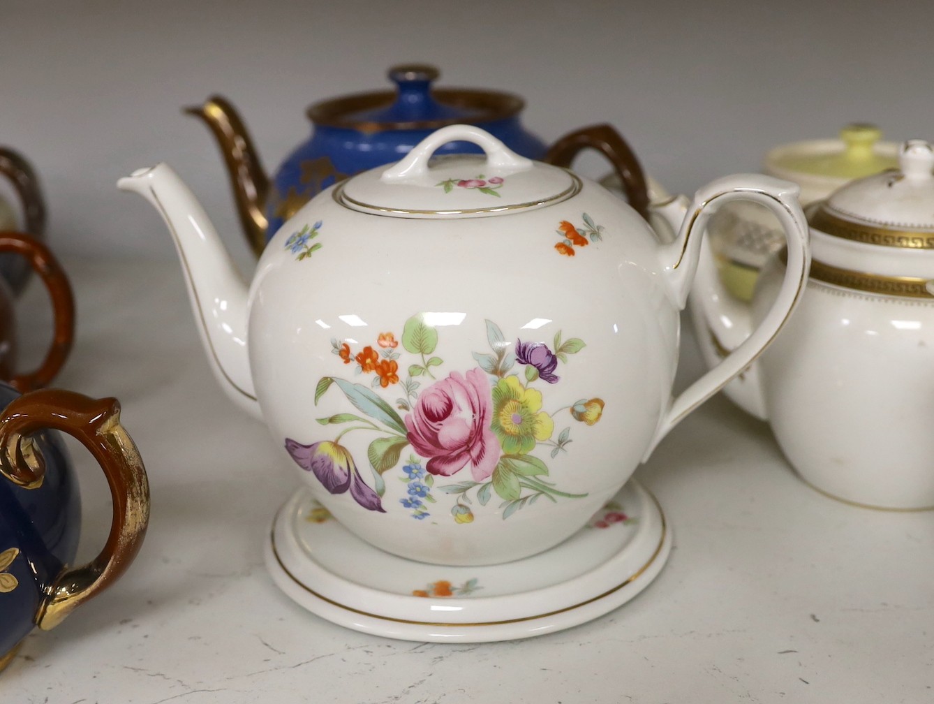 A quantity of various teapots including Belleek, Japanese Satsuma etc.